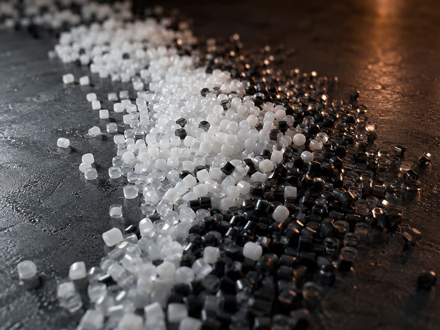 White, translucent and graphite polymer pellets.